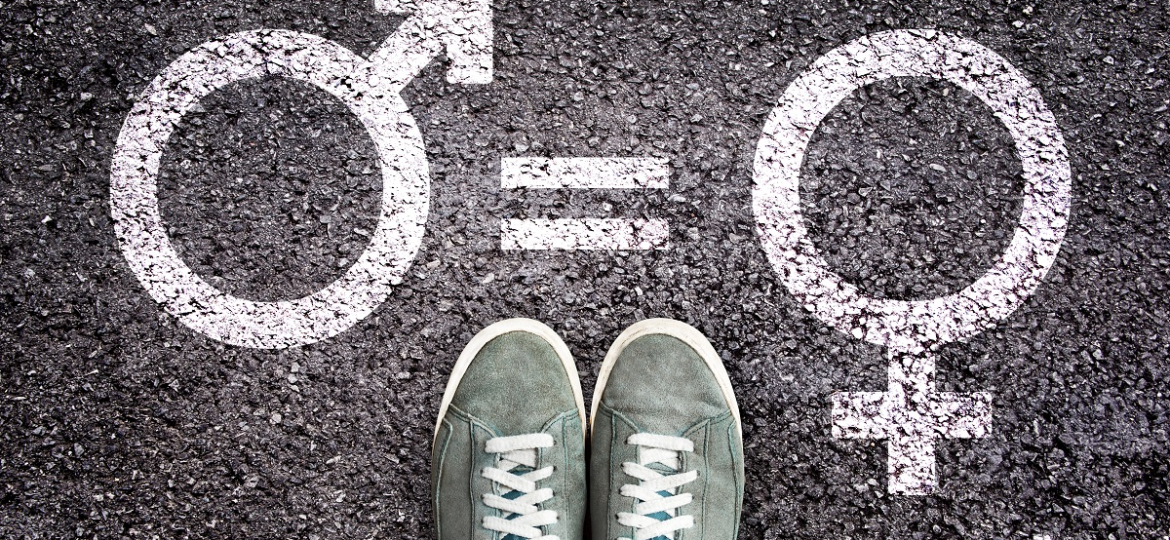 Sneaker shoes on asphalt background with gender symbols, gender equality education concept